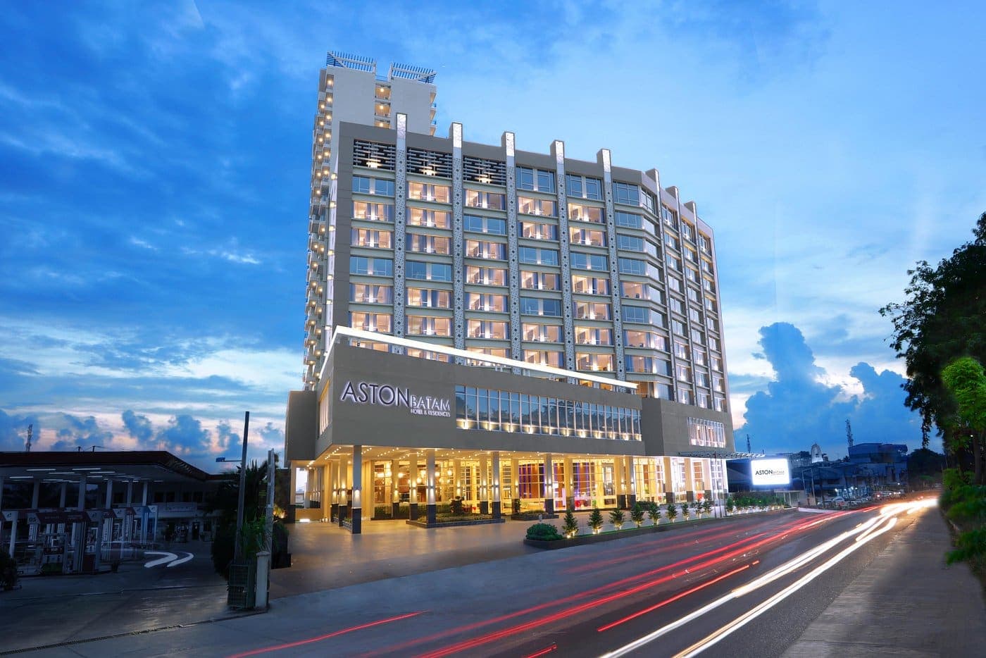 Aston Batam Hotel and Residences lit up at dusk