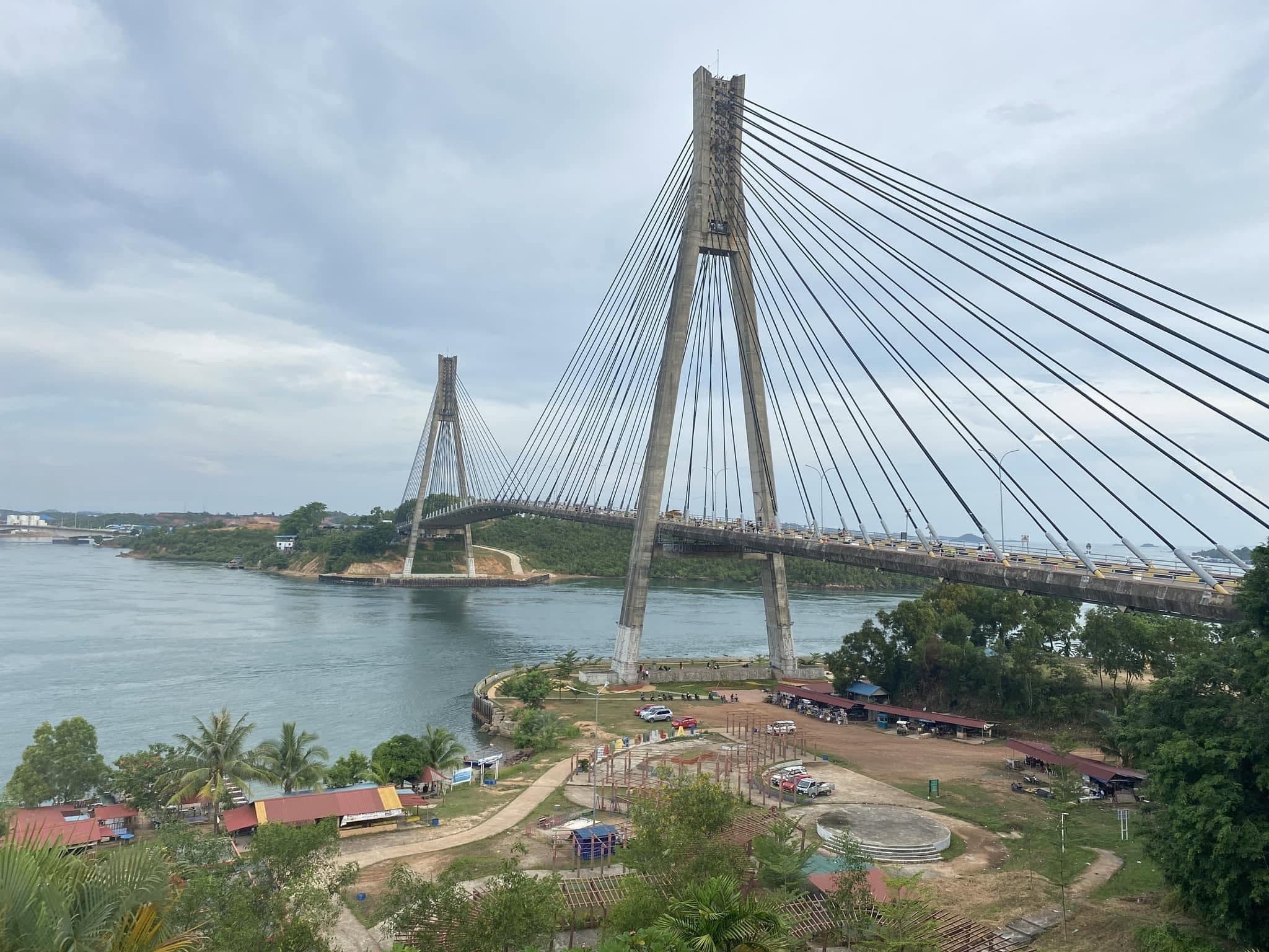 The Barelang Bridge from the hillside above, with the sea and the roadside stalls below