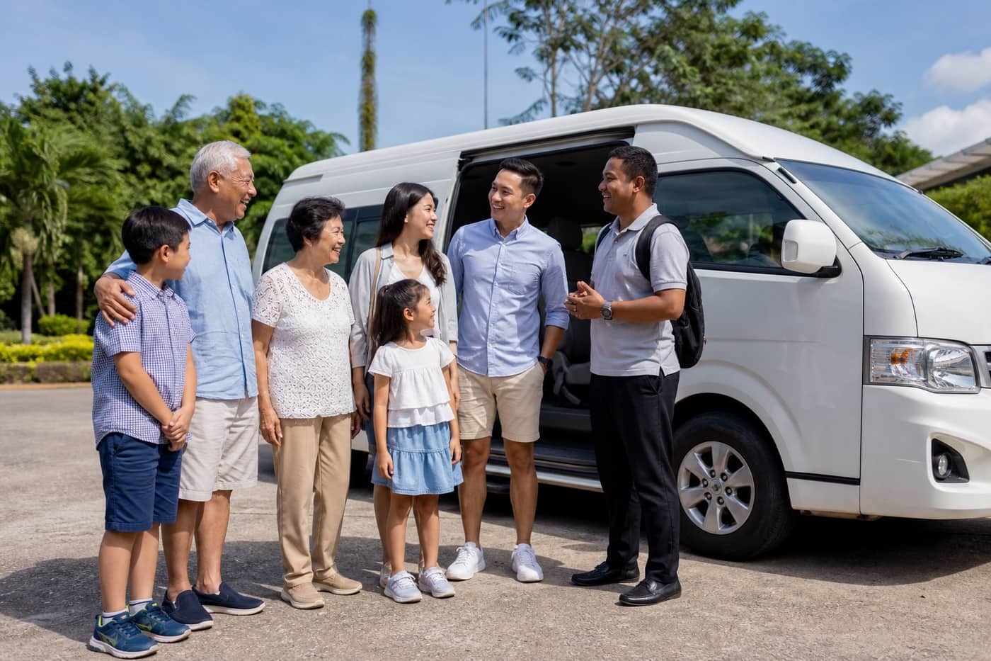 A Singaporean family with their InfoTravelBatam guide beside their private bus in Batam