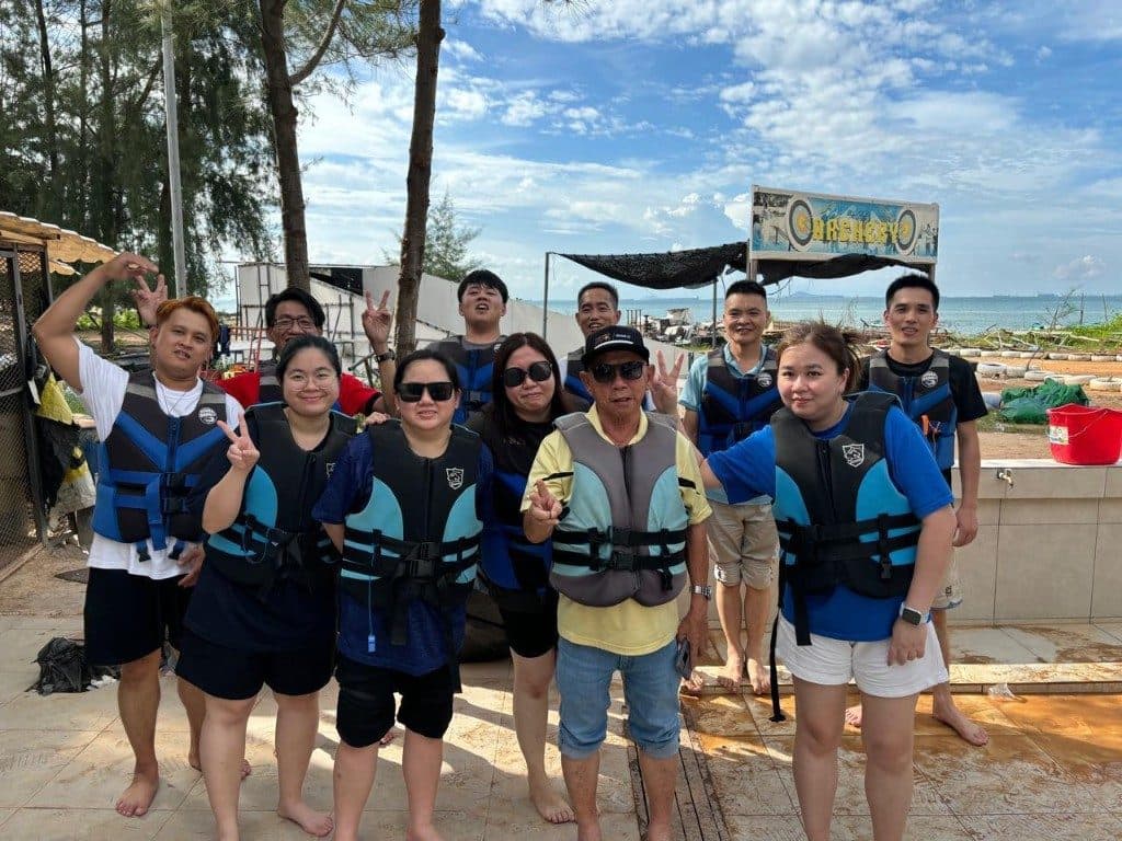 A group in life jackets on the sand, ready for watersports at a Batam beach