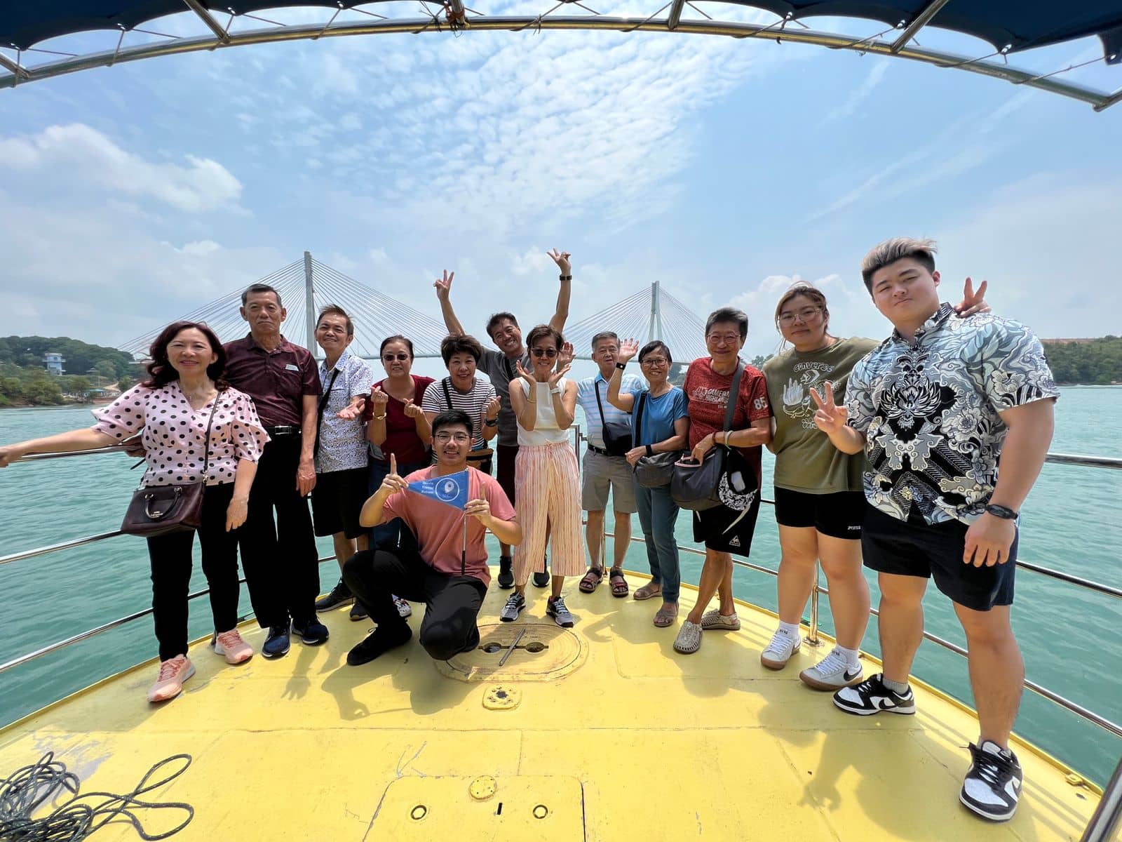 A tour group on a boat with Barelang Bridge behind them