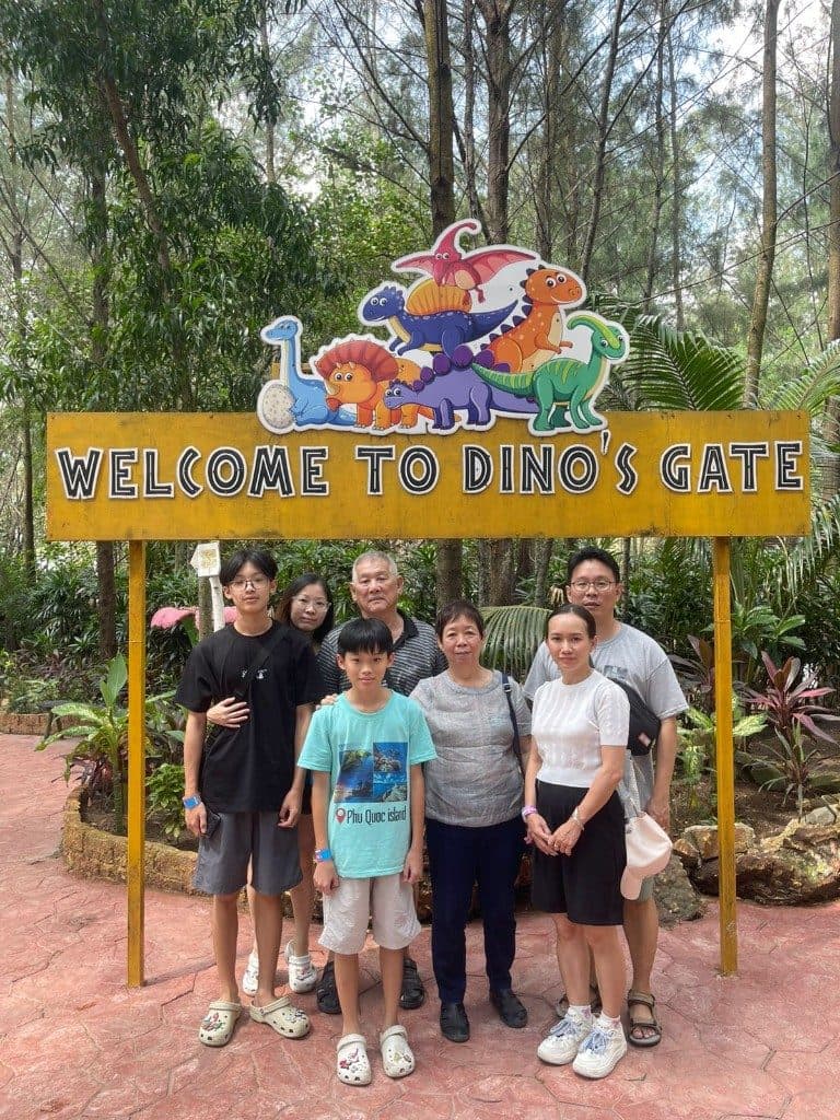 Three generations of one family under the Welcome to Dino's Gate sign