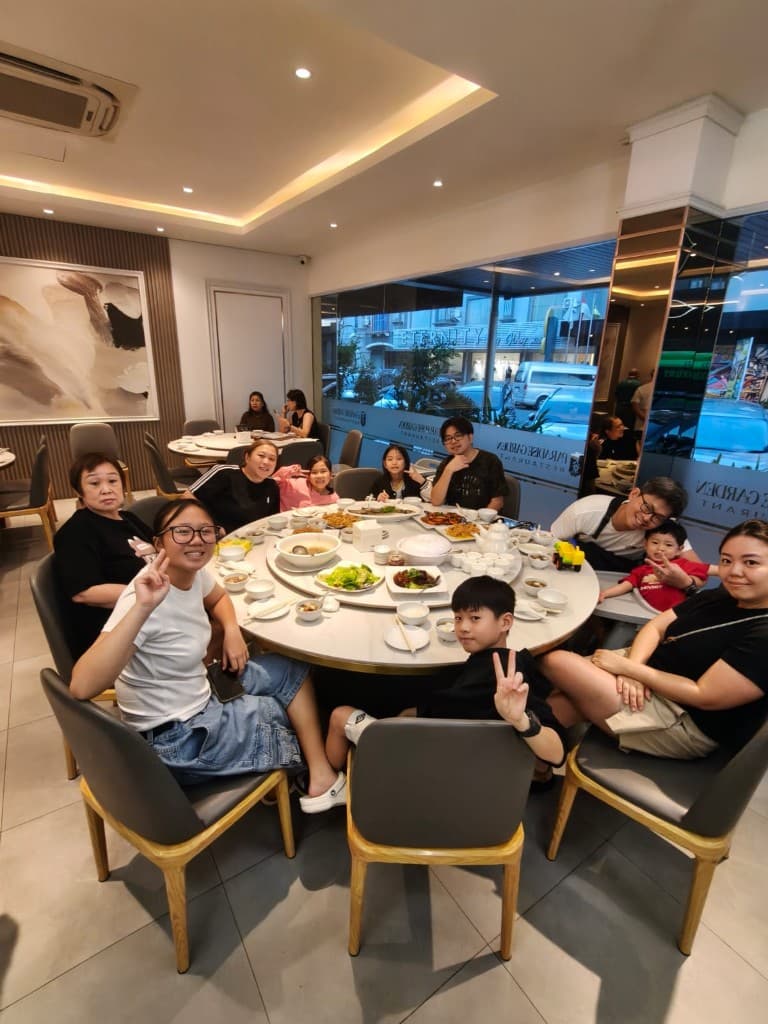 A family around a round table at a Batam restaurant before the ferry home